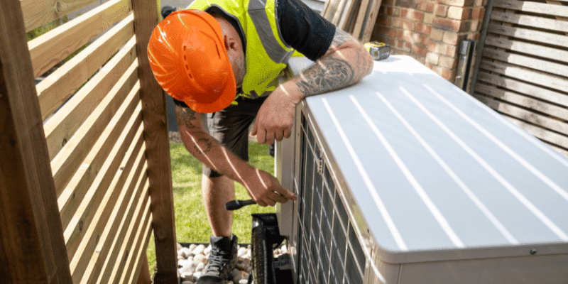Engineer inspecting the heat pump water heater installation
