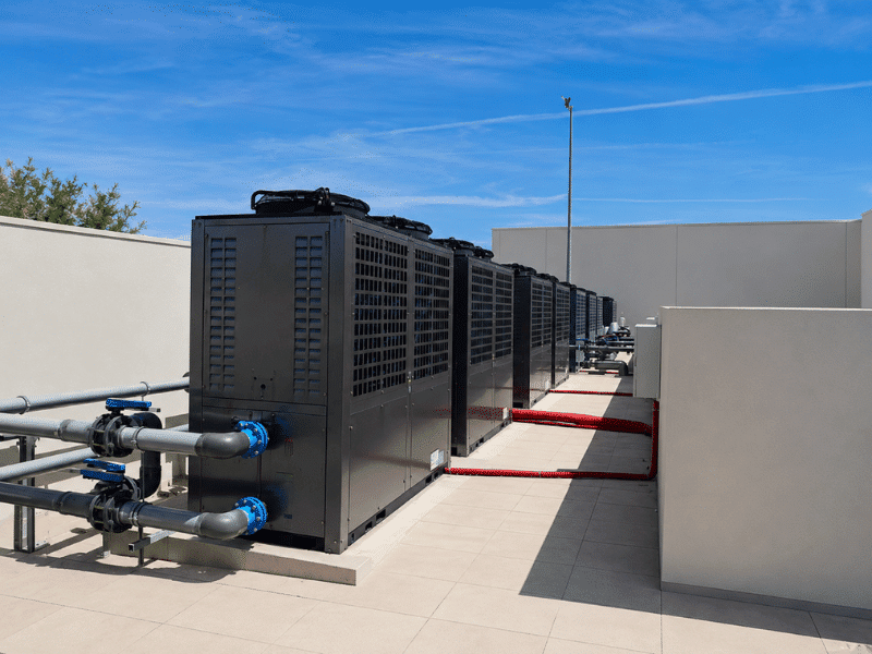 Commercial pool heating heat pump units installed at a public aquatic center in Athens, Greece, supporting competitive swimming with precise temperature control