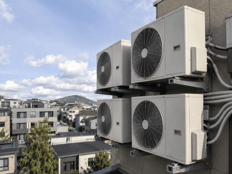 Multiple split air conditioner outdoor units installed on an apartment building for a multi-unit project