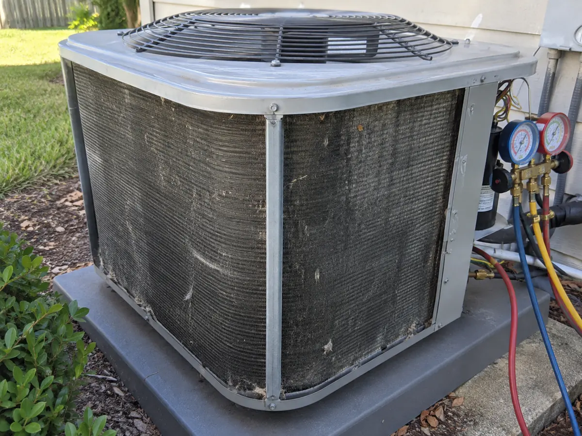 Outdoor HVAC inspection focused on coil and airflow checks before refrigerant diagnosis