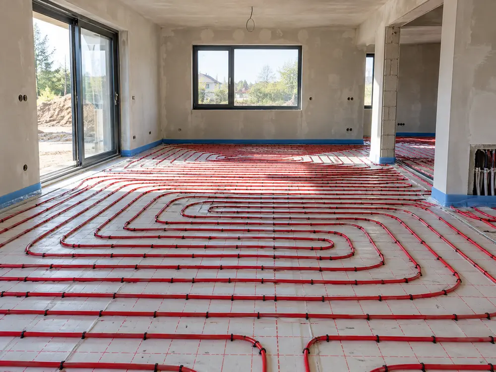 Illustrative scene: underfloor heating pipes laid out in a new residential room